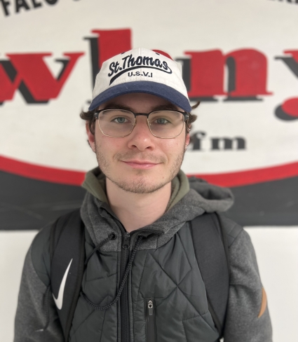 Evan Harrington wearing baseball hat and glasses