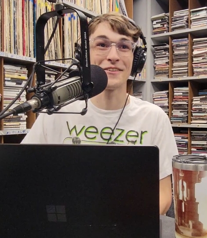 Man At radio Mic wearing headphones